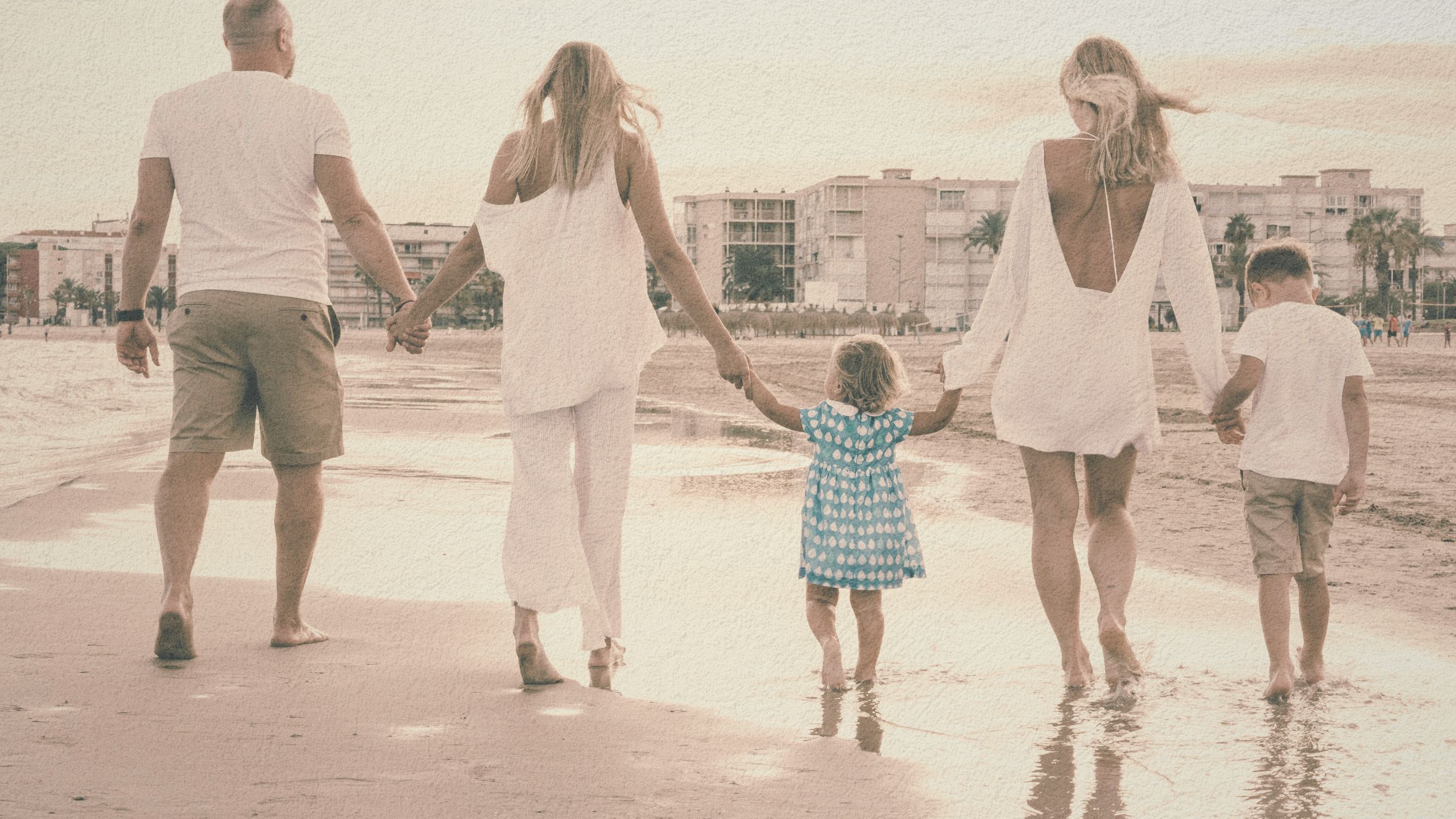 Family walking together along the beach