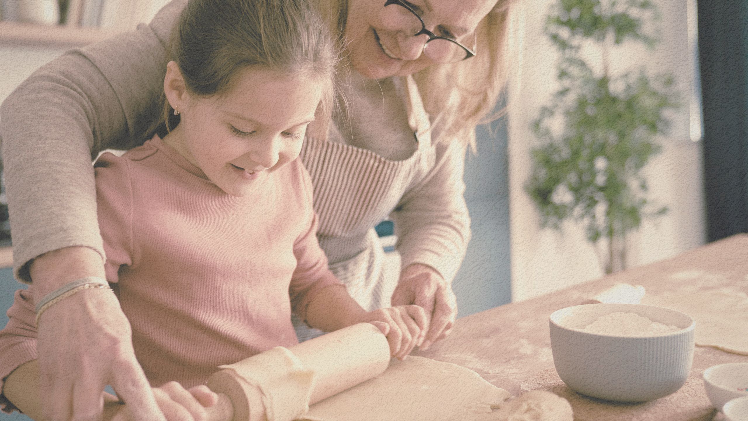 Grandma and granddaughter baking together